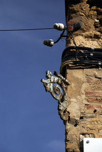 Low angle view of old building against blue sky