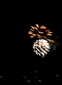 Low angle view of firework display at night