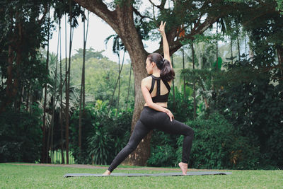 Full length of woman exercising at park