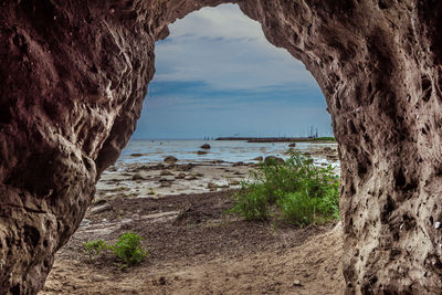 Scenic view of sea seen through cave