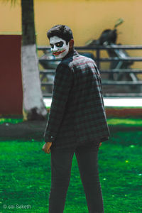 Portrait of young man standing on field