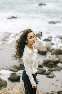 Full length of woman standing on rock