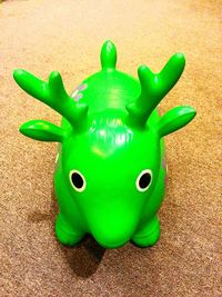 Close-up of green toy on sand