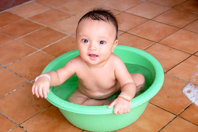 High angle view of boy sitting in swimming pool