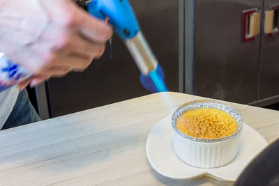 Torch caramelizing creme brulee