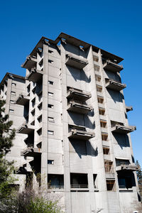 Low angle view of building against clear blue sky