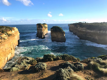 Scenic view of rocks in sea against sky