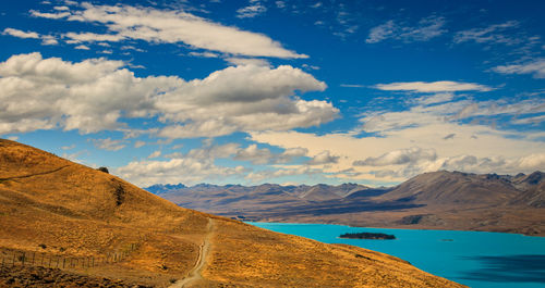 Scenic view of mountains against cloudy sky