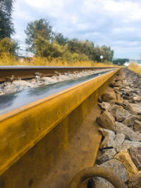 Surface level of railroad track against sky