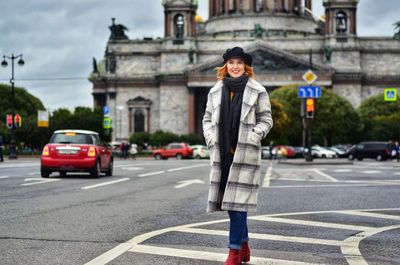 Young woman walking on street in city