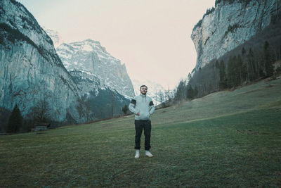 Full length of man standing on land against sky