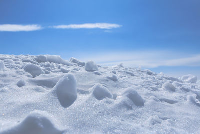 Scenic view of snow covered land against sky