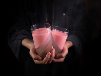 Midsection of woman holding drink