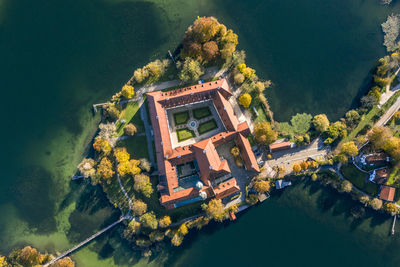 High angle view of abandoned building by lake