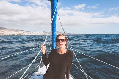 Portrait of young woman sitting in boat on sea