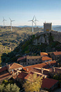 View of sortelha castle and antique stone houses and wind turbines, in portugal