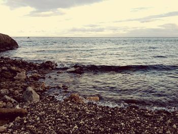 Scenic view of sea against cloudy sky