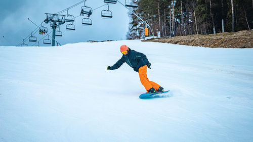 Man skiing on snow covered field