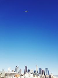 Low angle view of buildings against clear blue sky