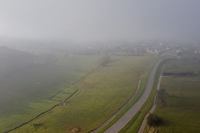 Scenic view of landscape against sky during foggy weather