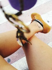 Low section of woman standing on tiled floor