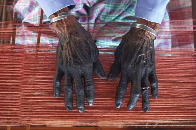 Black hand because of the natural coloring of cloth tradition