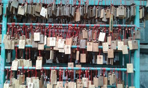 Close-up of prayer blocks hanging outdoors