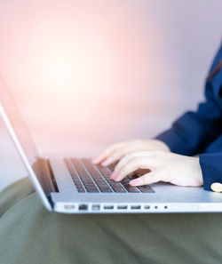 Midsection of man using laptop on table