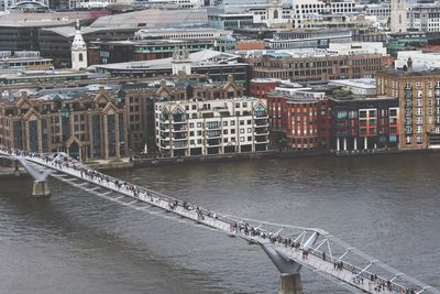 High angle view of people walking on london millennium footbridge over thames river
