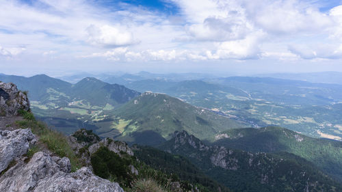 View on green hilly landscape with blue skies from the summit of a mountain, slovakia, europe