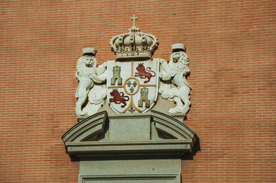 Low angle view of statue against wall