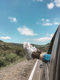 Relaxed woman's feet traveling on the mountain on a sunny day