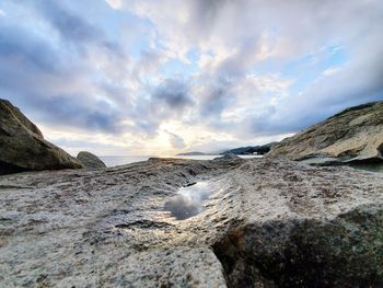 Rocks on beach against sky