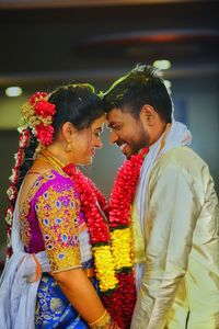 Wedding hindu couple seeing eachother wearing flower garlands