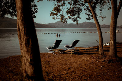 Empty deckchairs at lakeshore