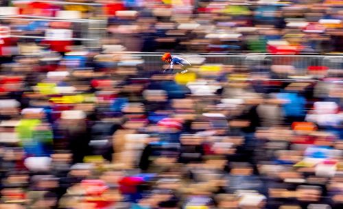 Blurred motion of people walking on street