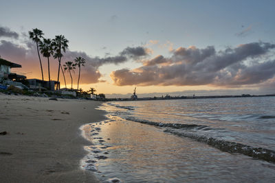 Scenic view of beach against sky during sunset