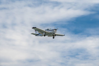 Low angle view of airplane flying in sky