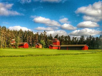 Scenic view of grassy field against cloudy sky