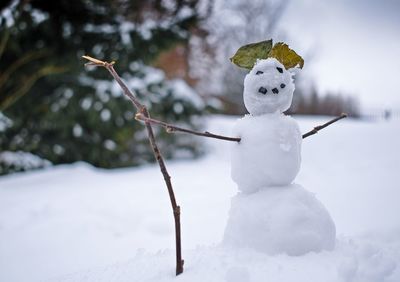 White toy on snow covered land during winter