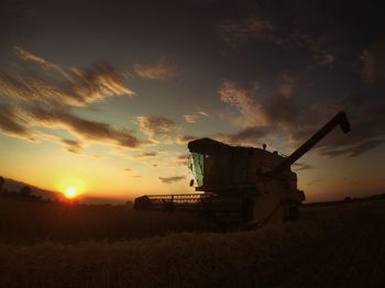 Scenic view of field against sky at sunset