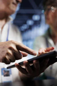 Midsection of man using mobile phone