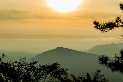 Scenic view of silhouette mountains against sky at sunset