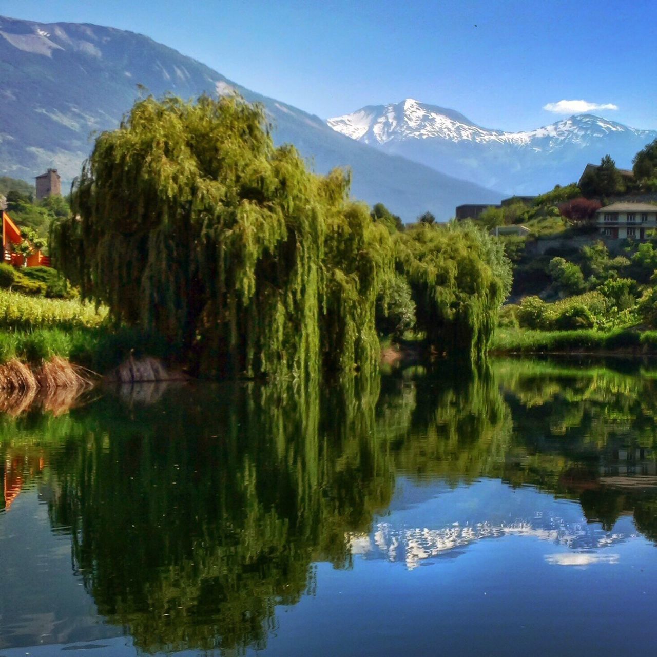 mountain, water, tree, tranquil scene, tranquility, sky, scenics, reflection, beauty in nature, lake, nature, mountain range, river, waterfront, idyllic, landscape, cloud - sky, day, outdoors, no people