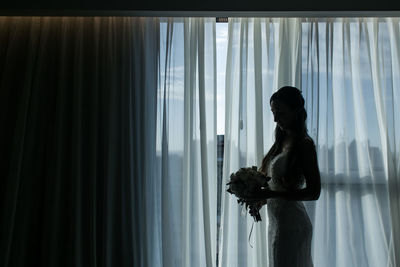 Woman looking through window