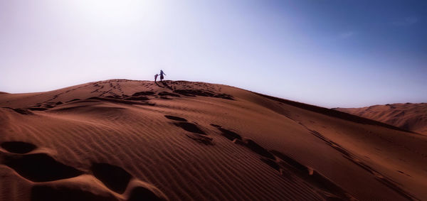 Scenic view of desert against clear sky