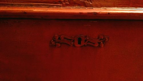 Close-up of red mailbox on wall