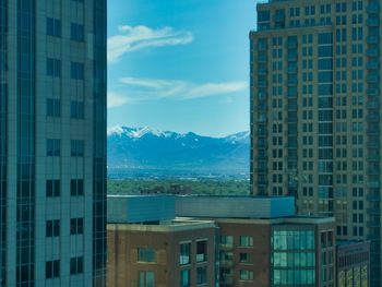 Buildings in city against blue sky