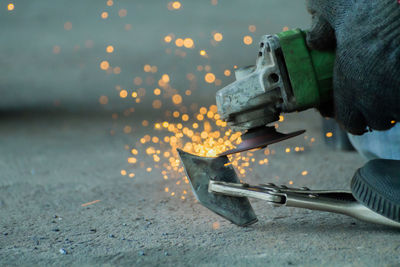 Cropped image of person molding shape of metal at workshop