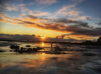 Scenic view of beach against sky during sunset